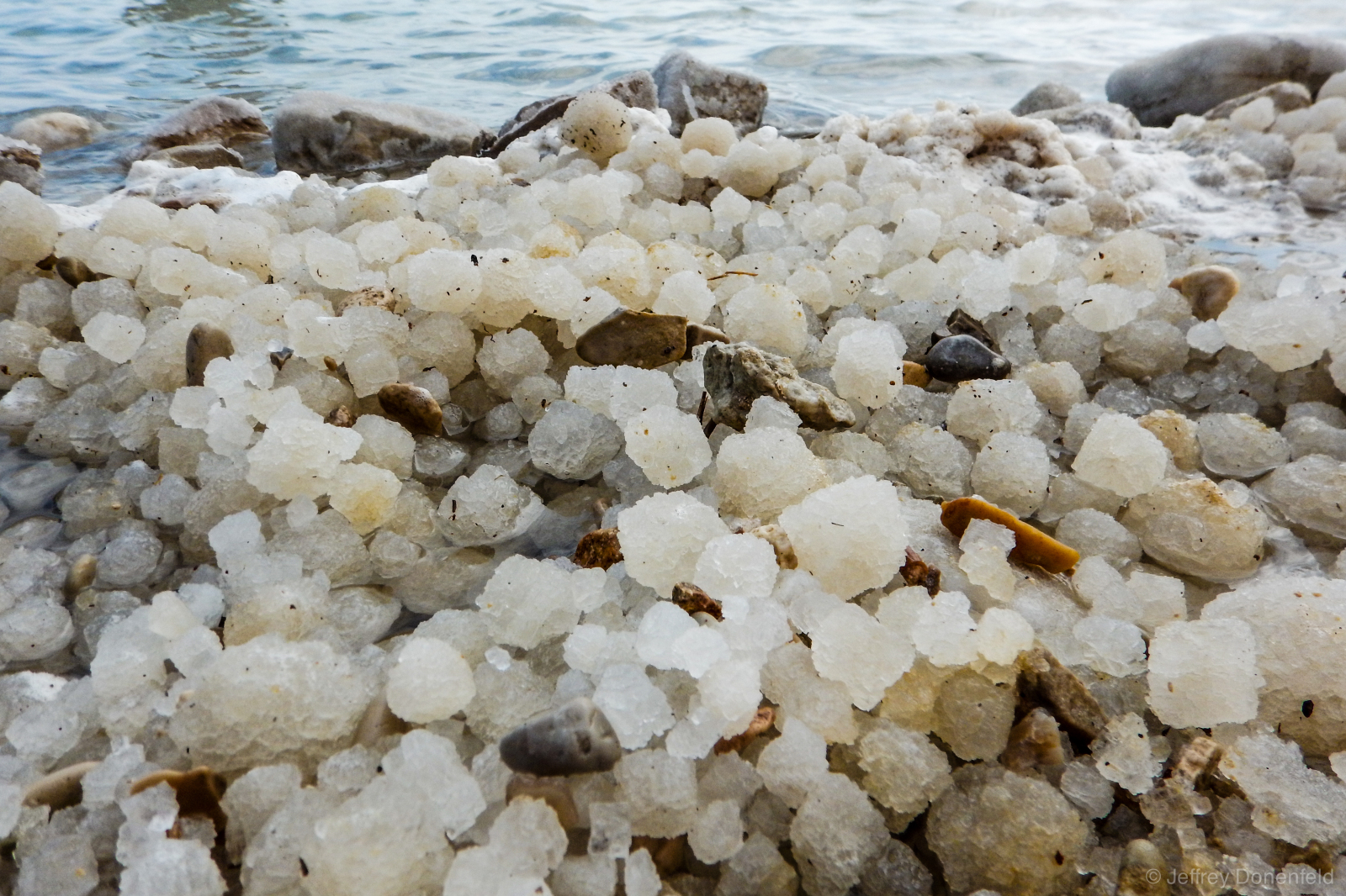 Balls of salt wash ashore at the Dead Sea.