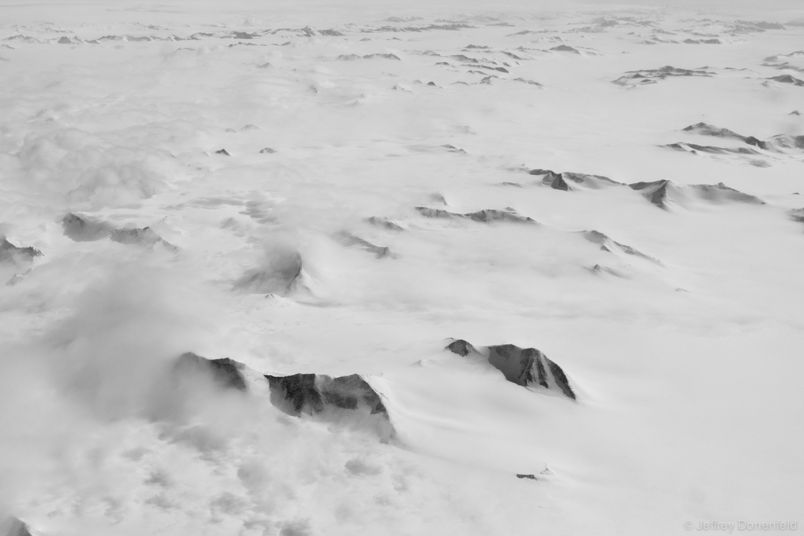 Massive peaks of the Trans-Antarctic Mountains poke out of the polar ice cap. Beautiful.