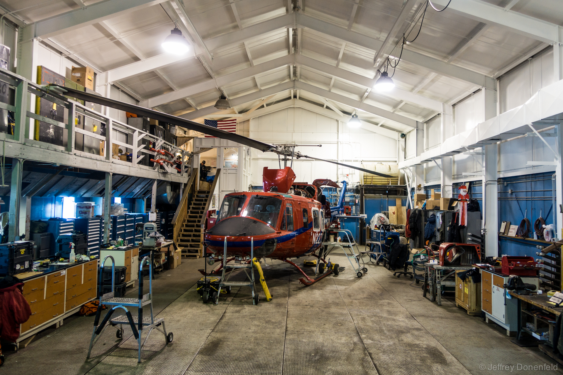 Inside the McMurdo helicopter hanger, a Bell 212 sits for maintenance.