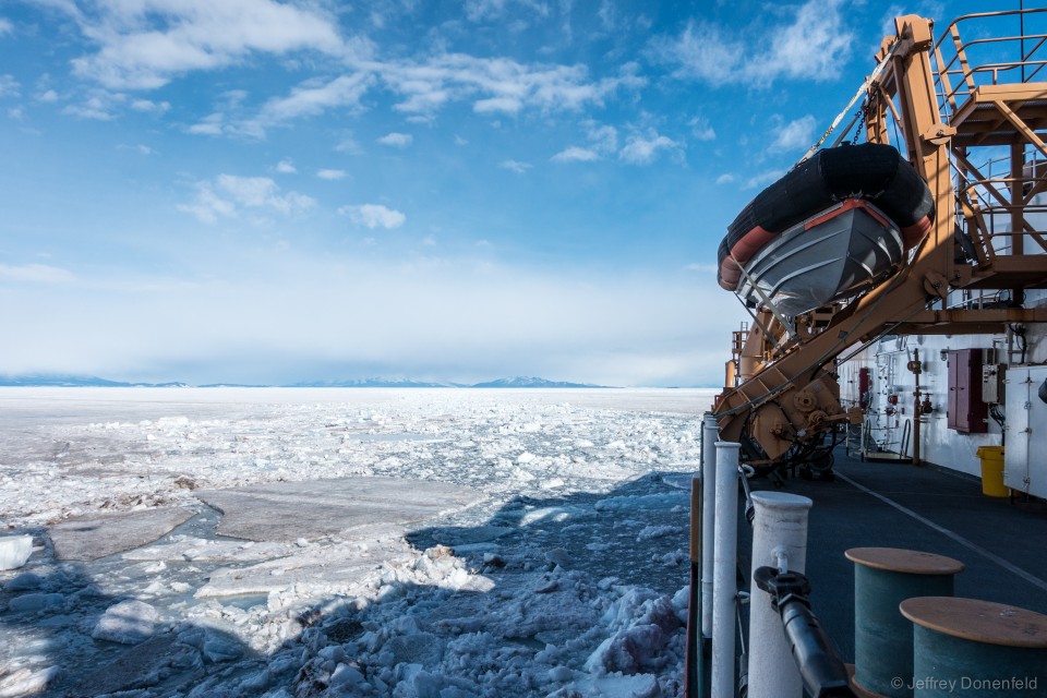 Looking aft off the starboard side, the ice slowly refreezes.