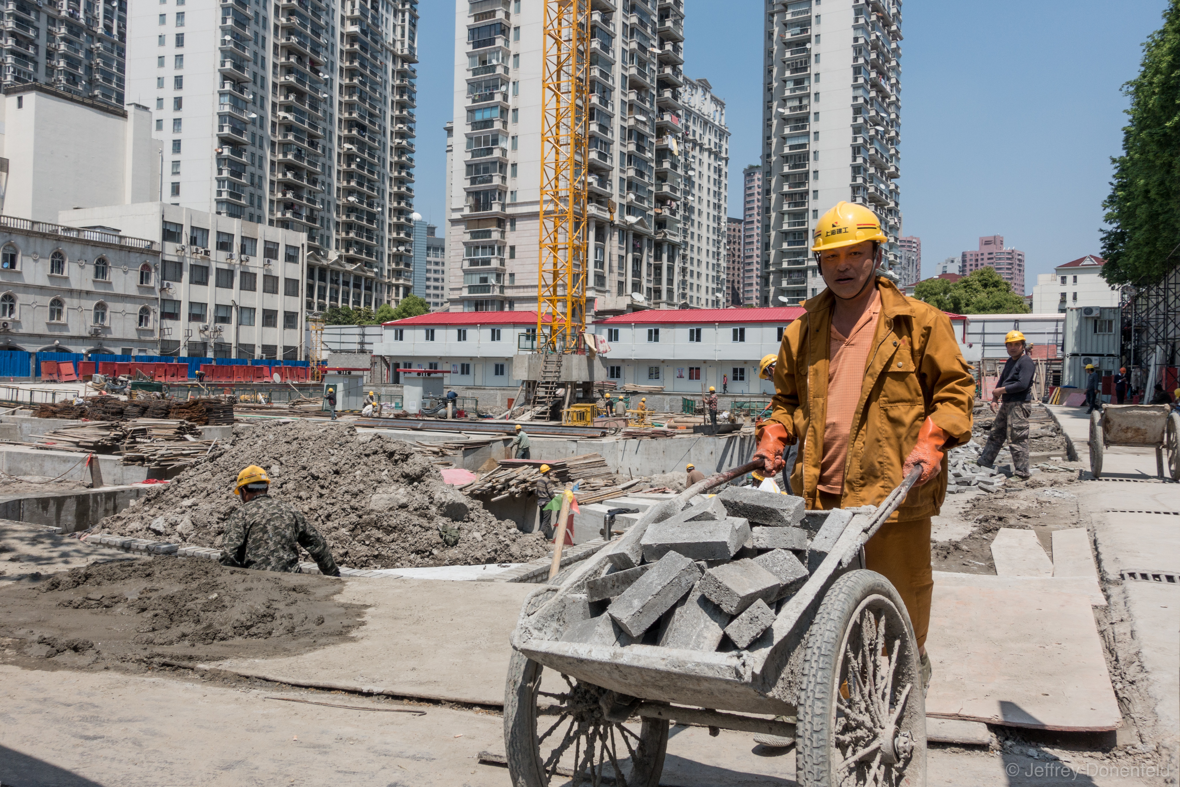 Walking down the street in Shanghai, this is a common scene - building going on everywhere. In order for buildings to be buit faster, they house workers directly on site, to cut out the commute, and maximize working hours.